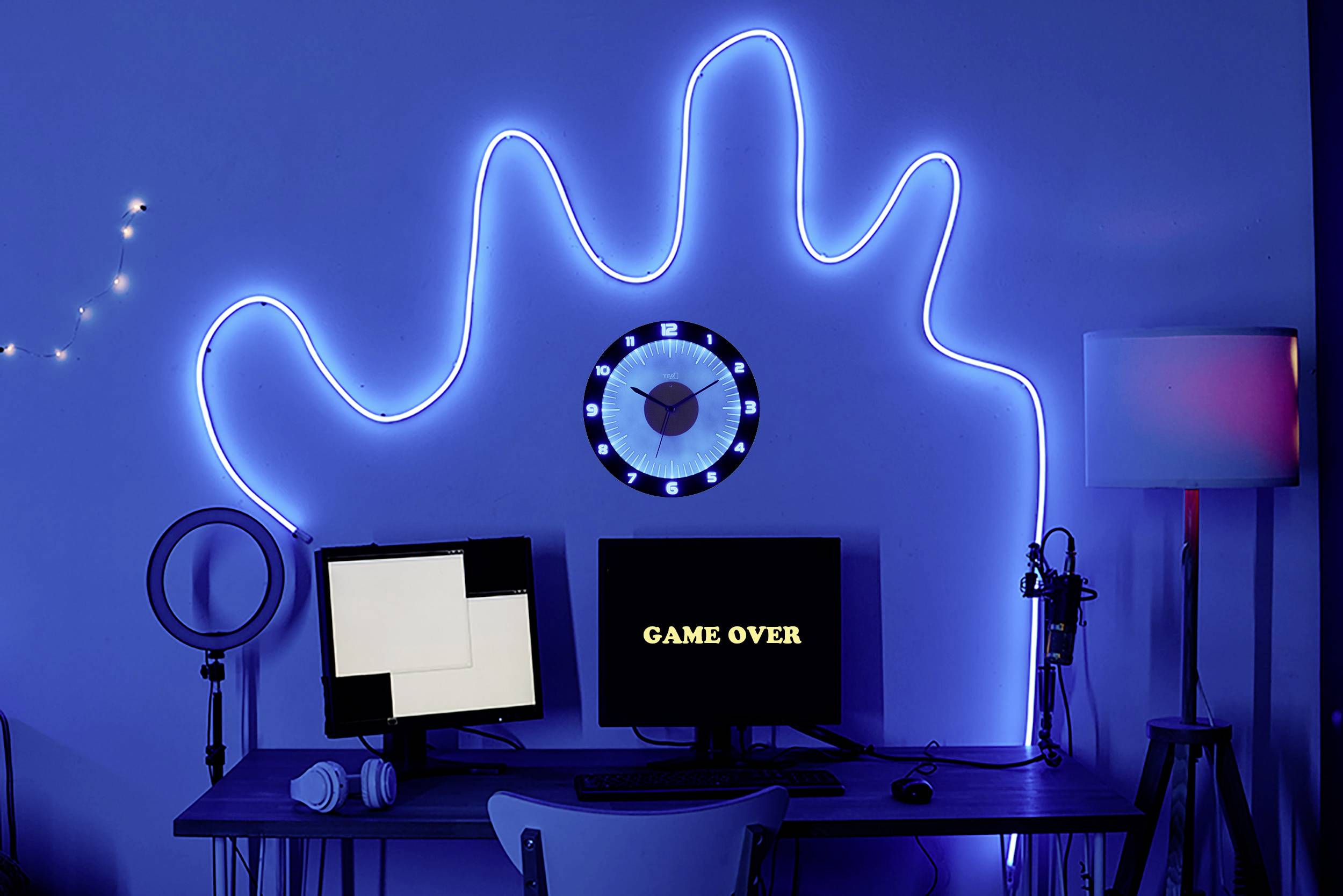 A blue room with an illuminated hand silhouette on the wall, a computer screen displaying 'GAME OVER', a microphone, and a lamp.