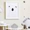 A children's bedroom with a drawing of a bear on the wall, decorative clouds, and a dinosaur toy on a table.