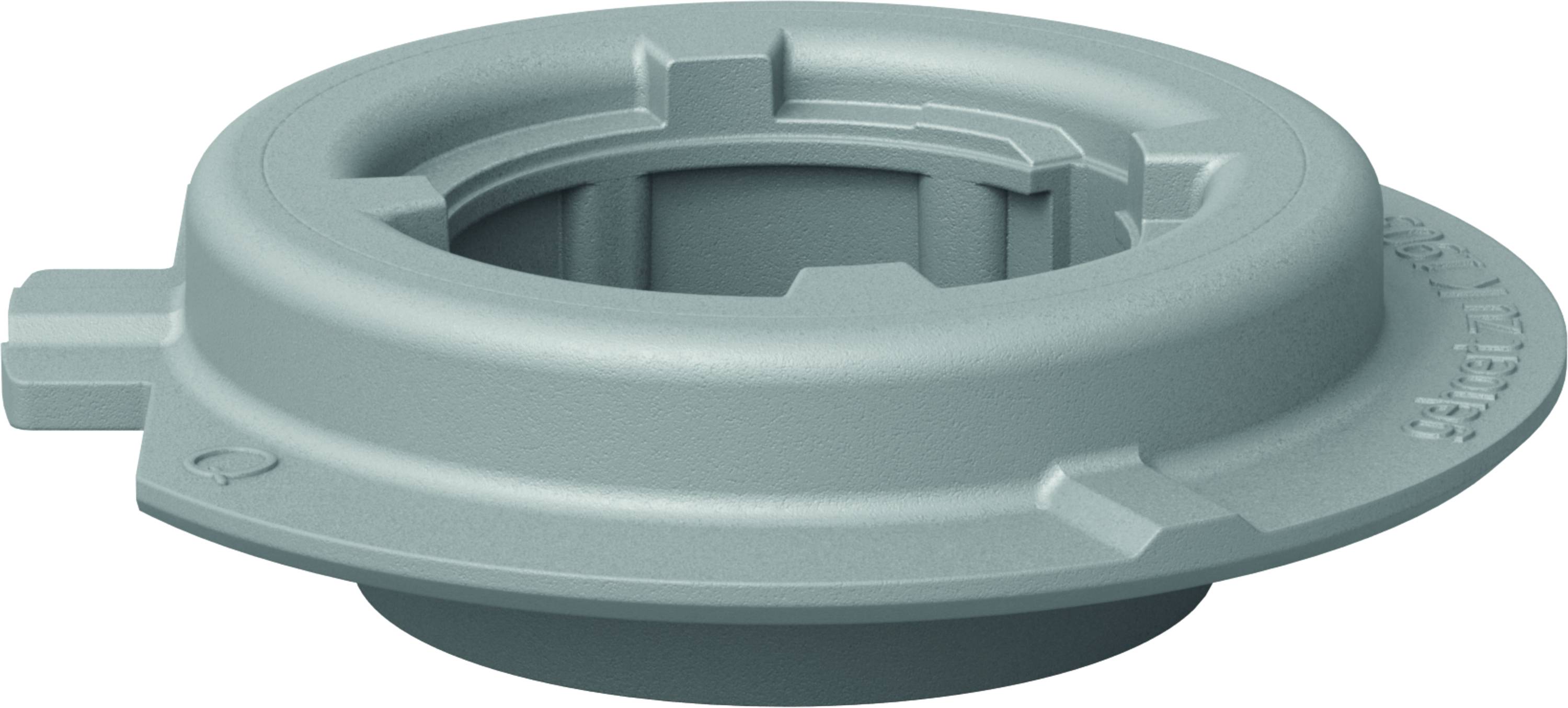 A grey, round machine component with multiple notches and a central opening, likely an adaptor or seal.