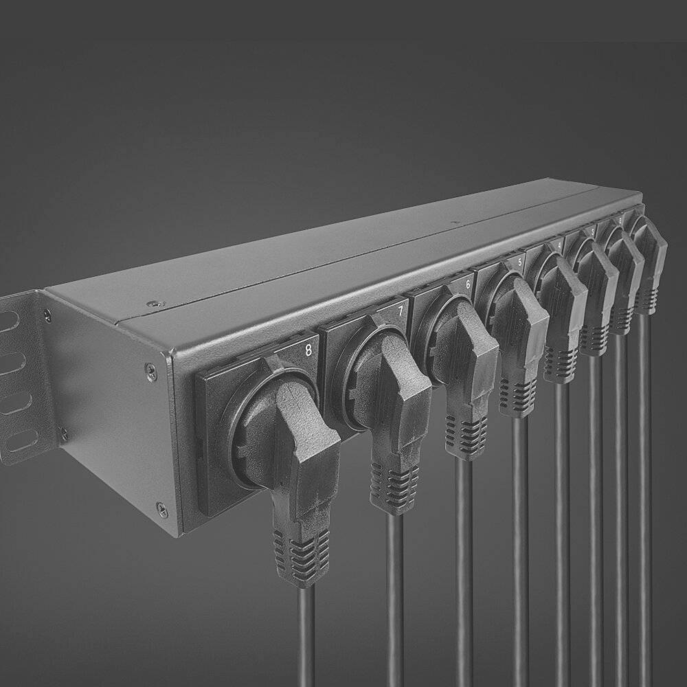 Eight-way multi-socket extension, fully occupied with connected cables, mounted in a grey casing.