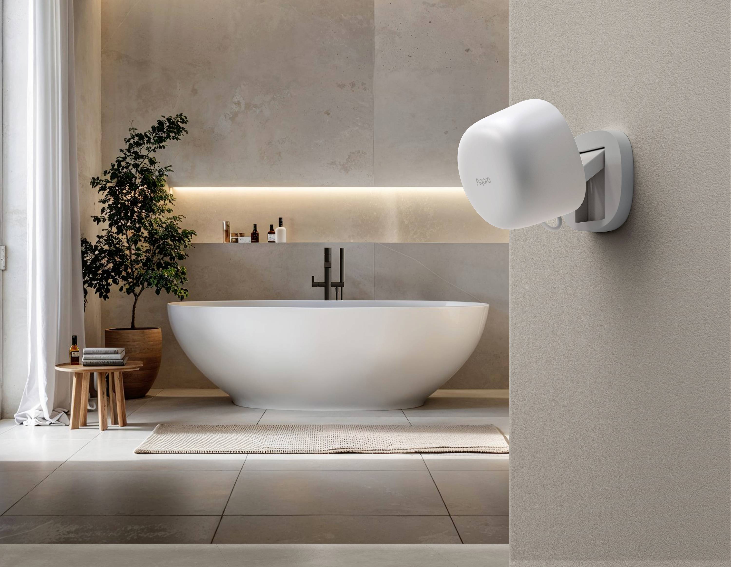 Freestanding bath in a modern bathroom with wall shelving and lighting; a WiFi router mounted on the wall in the foreground.