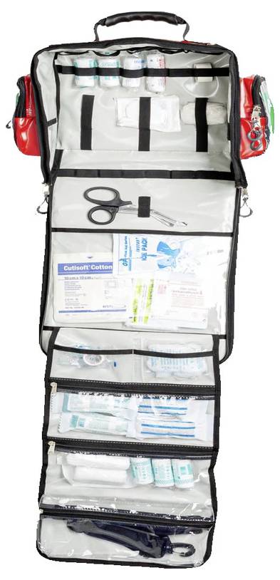 Open first aid kit with bandaging materials, scissors and various medical utensils, arranged in transparent compartments.