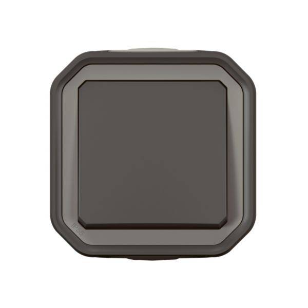 A brown square light switch with rounded corners, mounted on a wall.