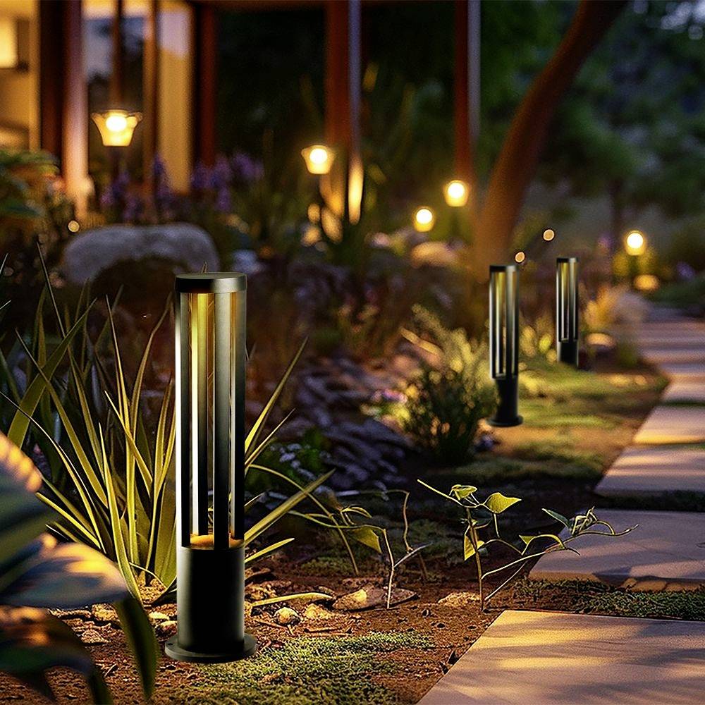 A illuminated garden path at dusk, lined with contemporary streetlamps and surrounded by lush vegetation.
