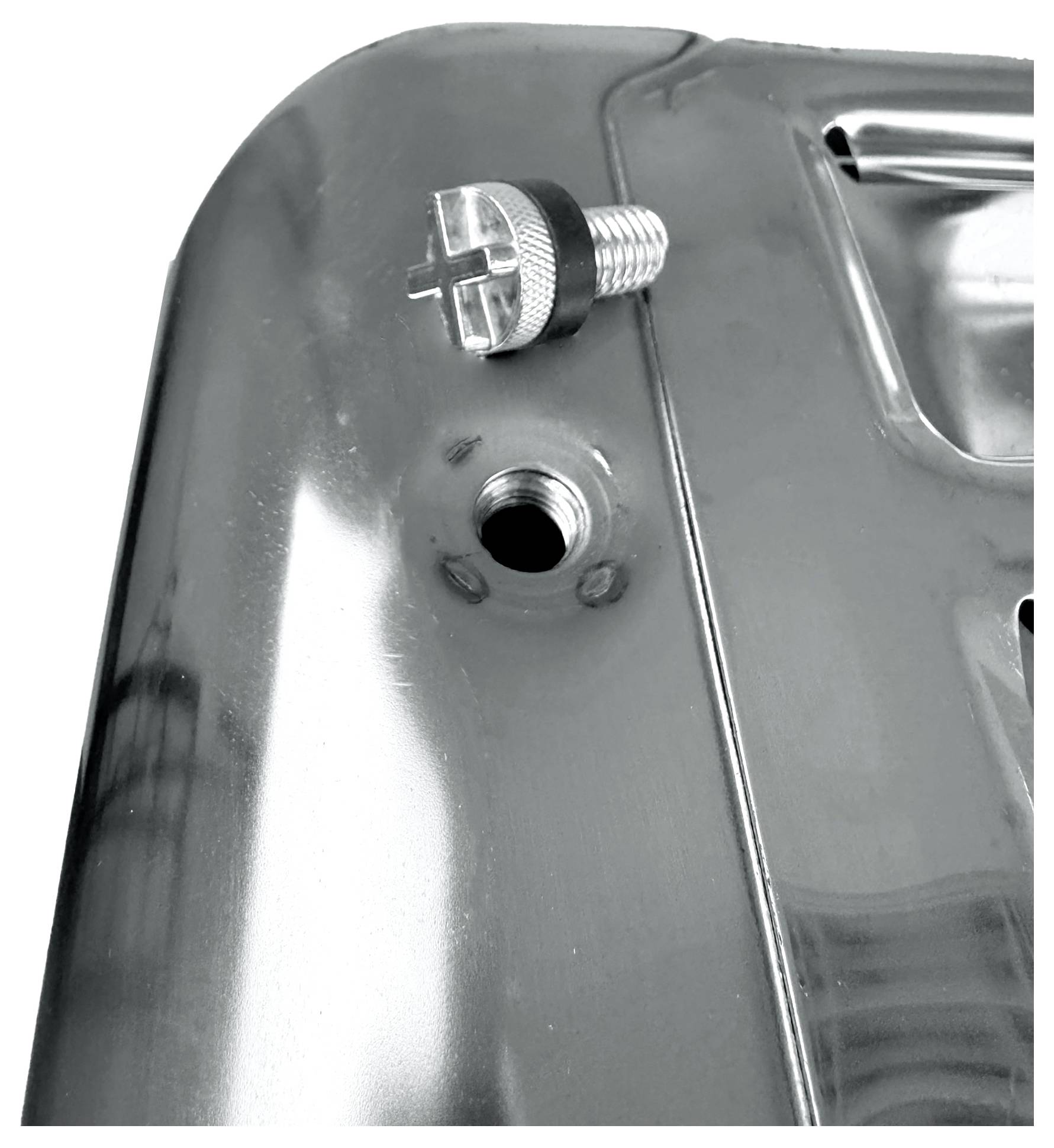 'Close-up of a grey metal component with a protruding screw and an open hole beside it.'