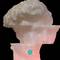 A sculpture of a head with the top section removed, revealing a brain, illuminated in pink. An 'M' logo visible at the bottom.