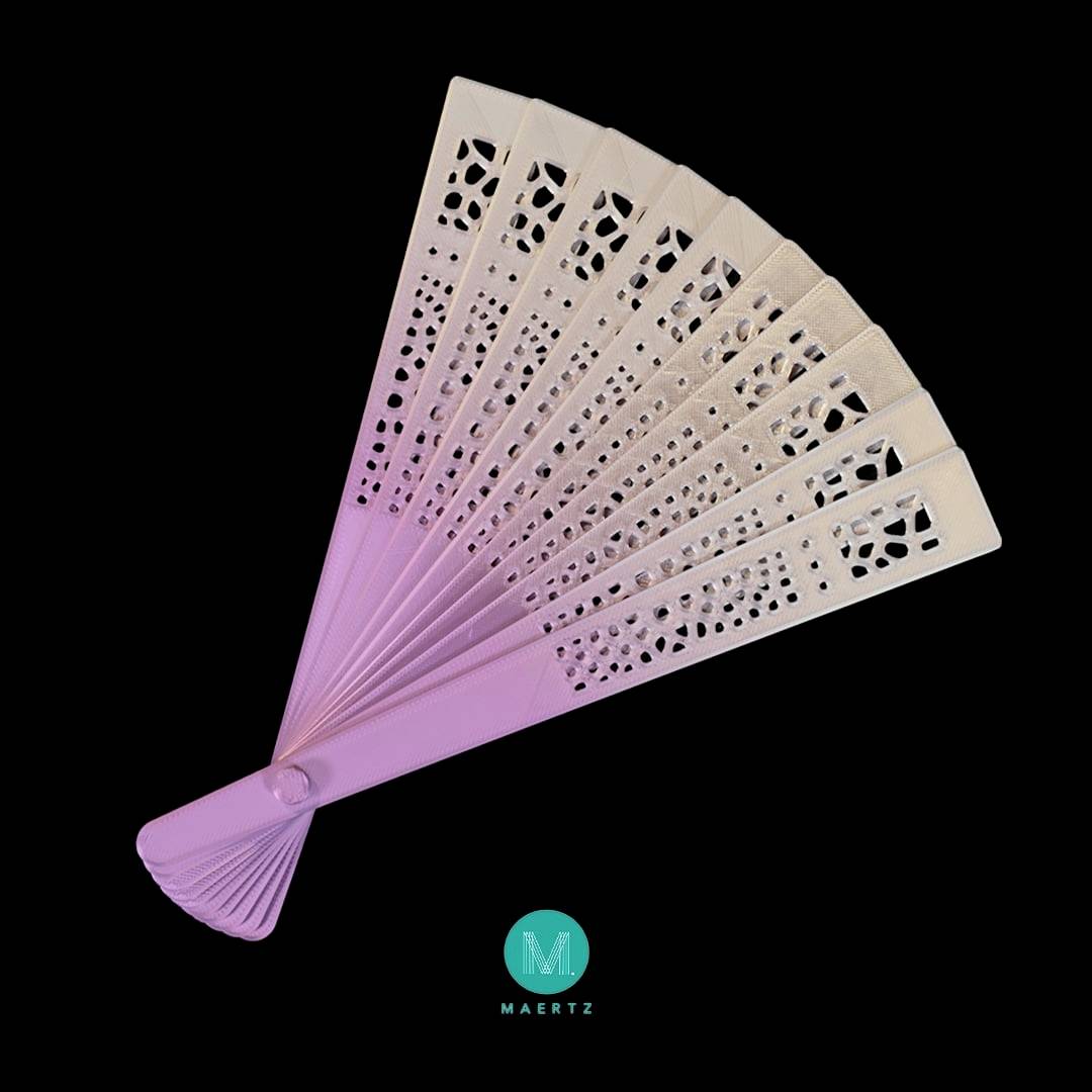 A pink fan with a filigree pattern on a black background. At the bottom is a blue logo with the letter 'M' and the word 'MAERTZ'.