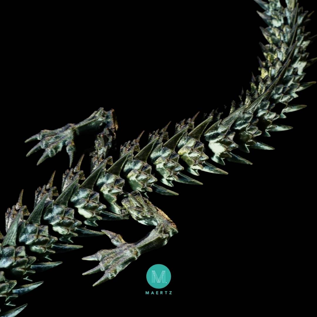 A close-up of an outstretched, spiky reptile tail against a black background; the image creates a dramatic, detailed impression.