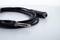 A black audio cable with a 6.35 mm jack plug and socket is lying on a white background.