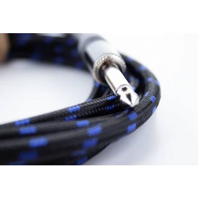 Close-up of a blue and black audio cable with a metal plug lying on a white surface.