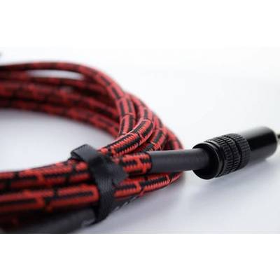 A red and black patterned audio cable with a plug, coiled and held together by a velcro strap.