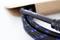 A black cable with blue stripes protrudes from an open brown cardboard box, part of a technical device or tool.