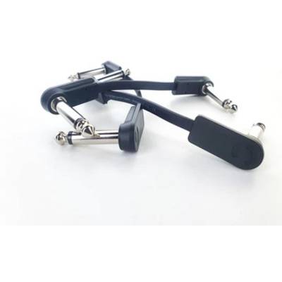 Four black cables with metal jack plugs lie untidily on a white background. They are used to connect audio devices.
