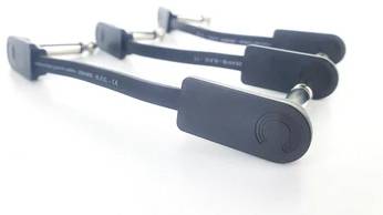 Three parallel black audio cables with metal connectors on a white background. One of the cables displays a subtle logo.