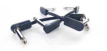 Four black and silver guitar patch cables with right-angled plugs on a white background.