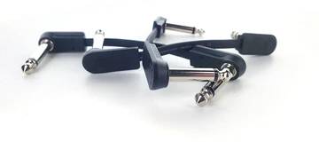 Several black guitar effects patch cables with metal connectors on a white background.
