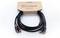 A black Cordial cinch cable with three plugs on each side. Packaging on top shows the 'Cordial elements' logo.