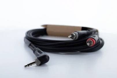 An audio cable with a 3.5mm jack plug on one side and two RCA plugs on the other, against a white background.