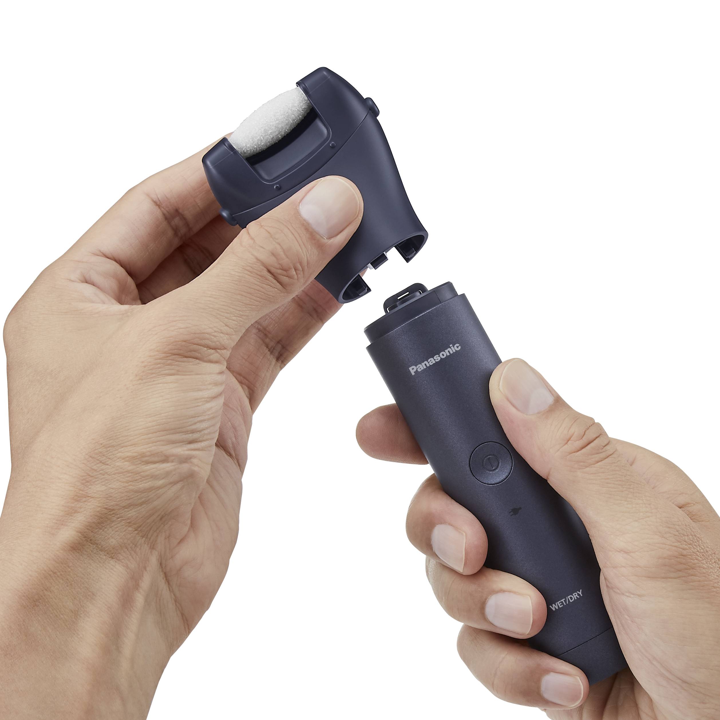 Two hands are holding a Panasonic electric foot care roller, ready for use.