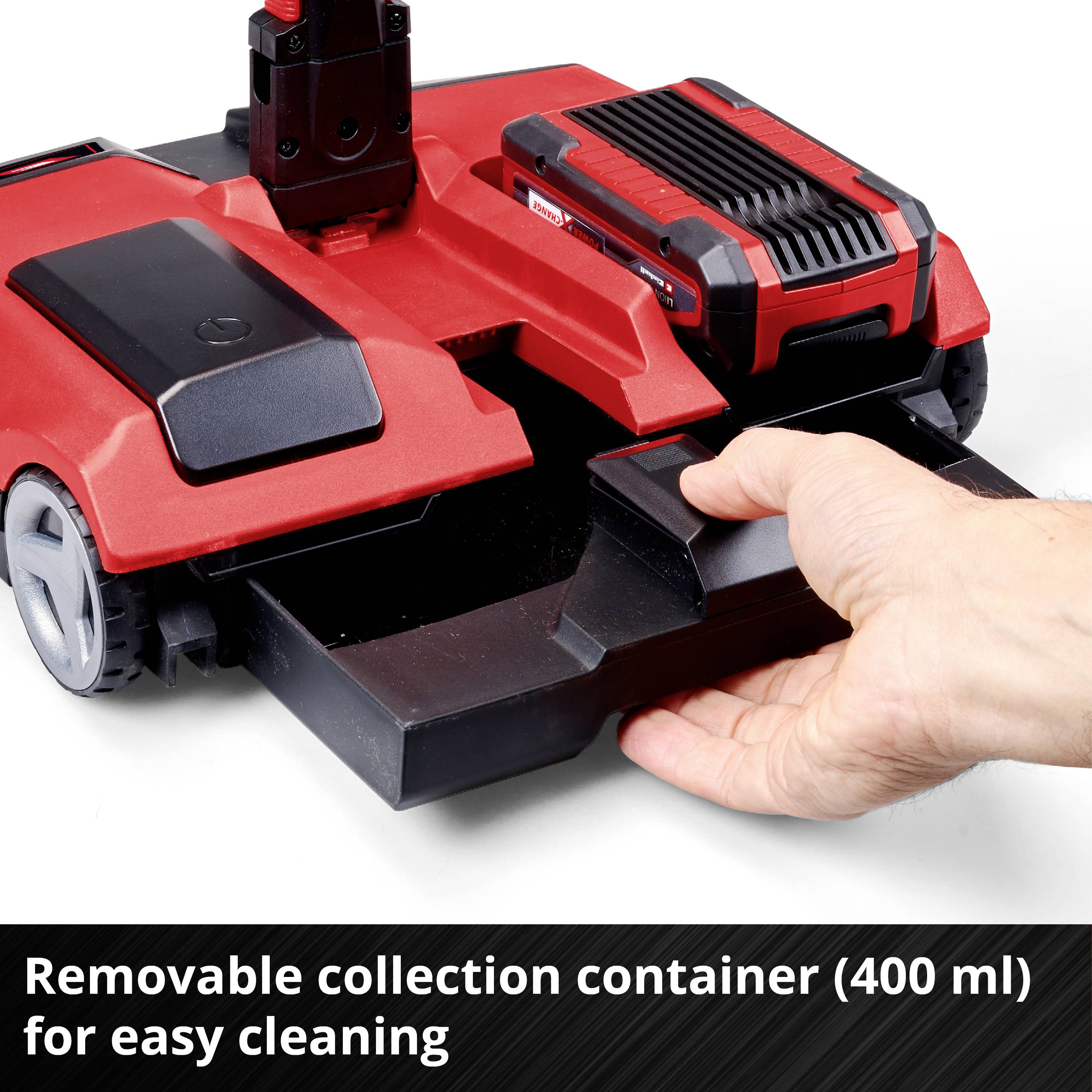 Red sweeping machine with removable collection container (400 ml) for easy cleaning. One hand pointing at the open container.