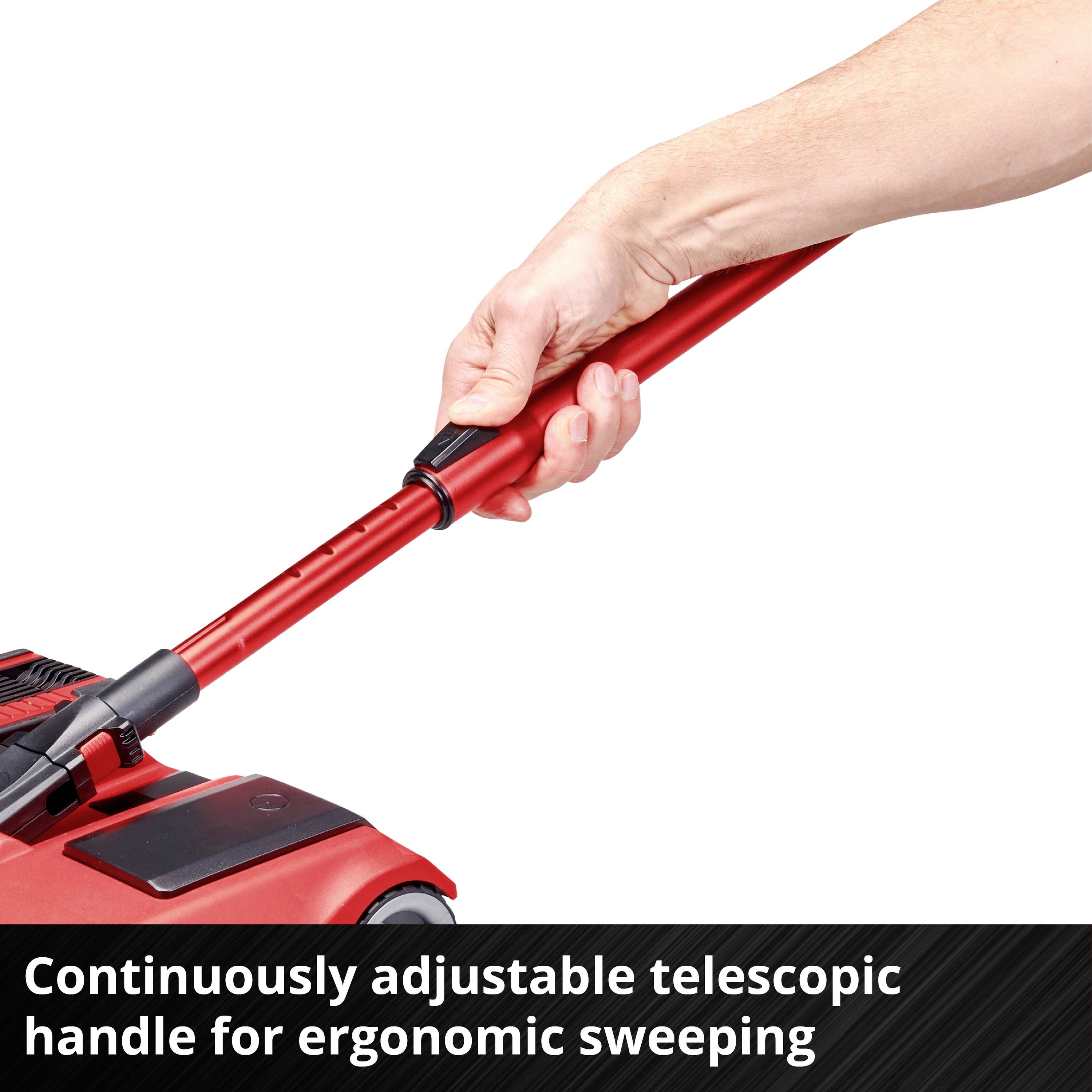 Telescopic handle of a red broom being adjusted. Text: 'Infinitely adjustable telescopic handle for ergonomic sweeping'