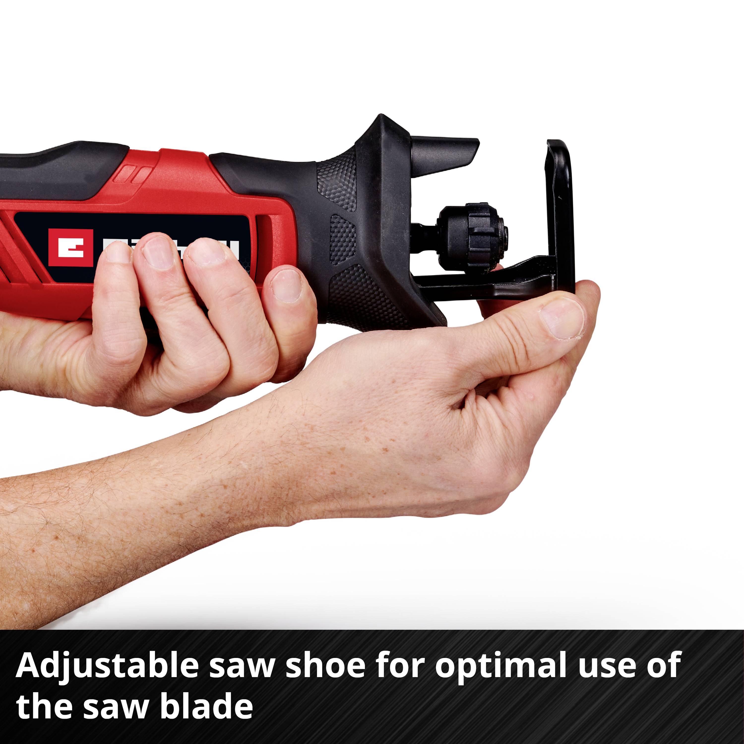 A person is holding a red and black saw with an adjustable saw shoe to demonstrate the optimal use of the saw blade.