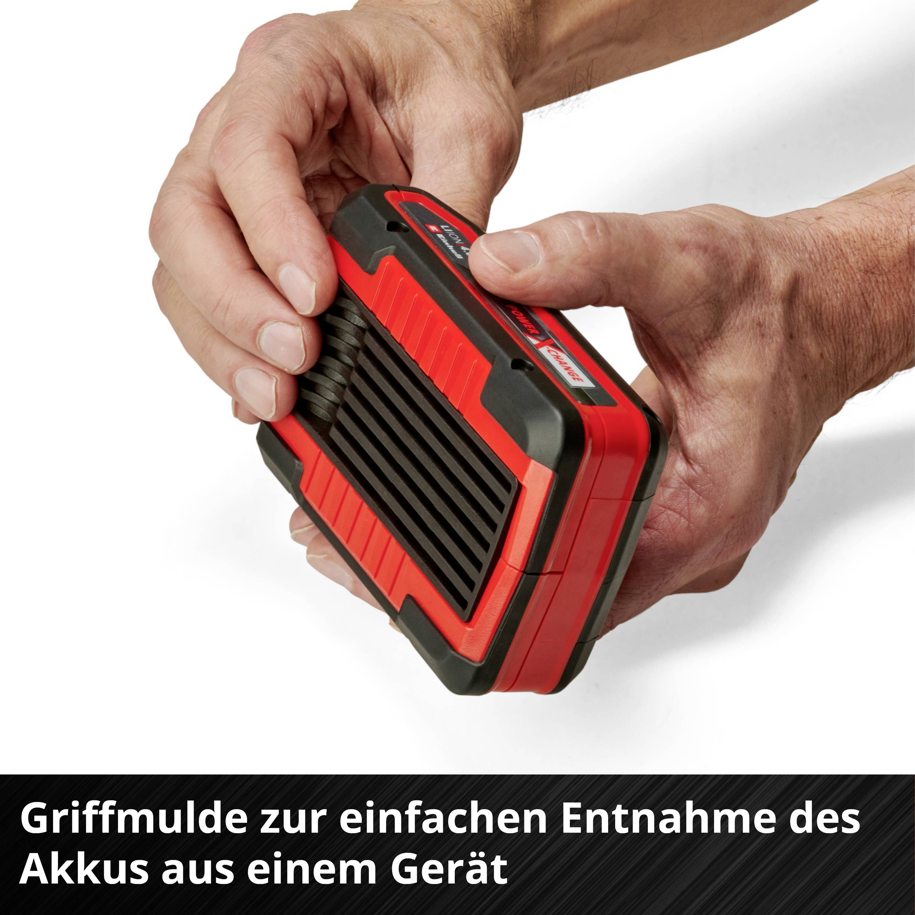 A hand removes a red battery from a device. A black text at the edge of the image describes the grip recess for removal.