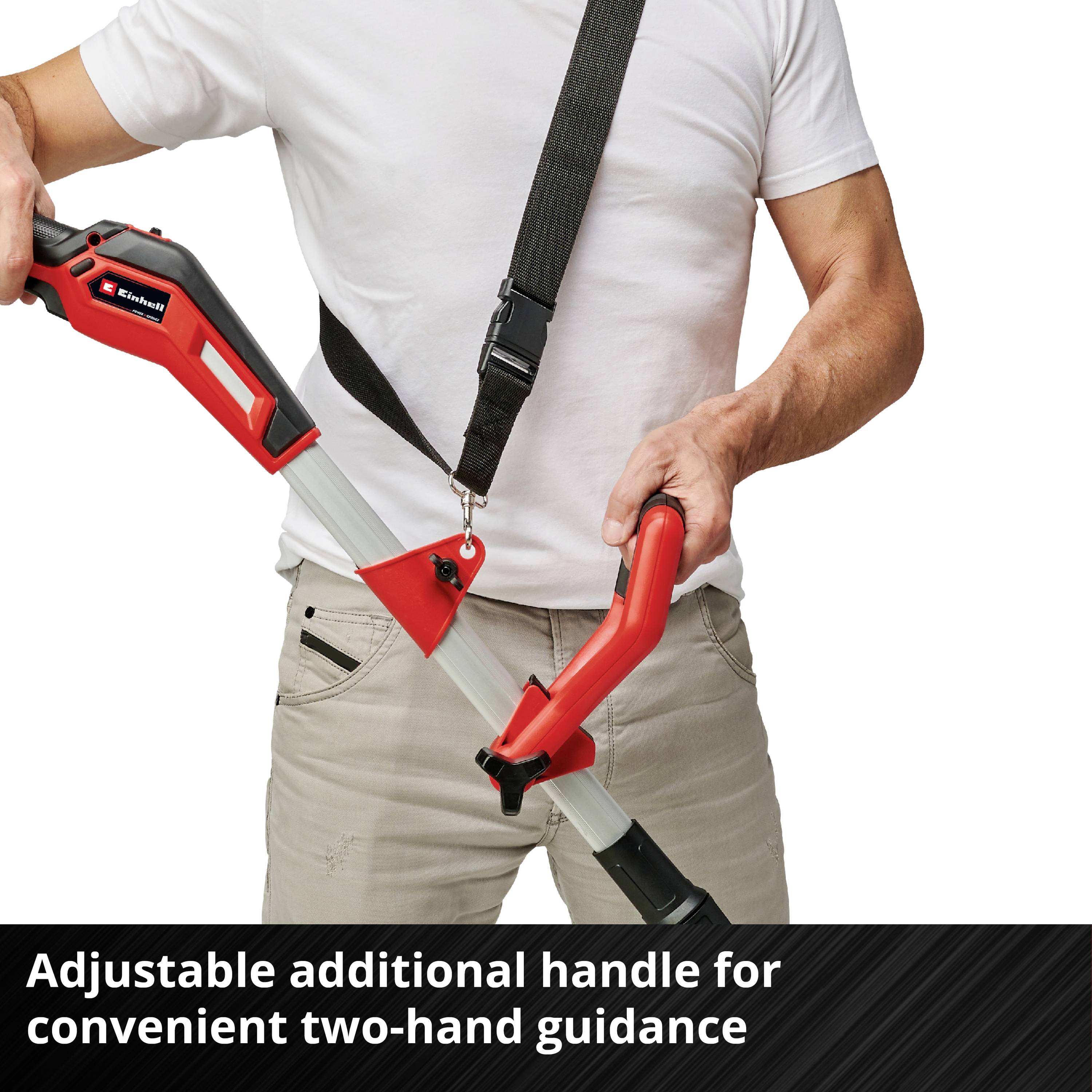 A person is holding a red hedge trimmer with an adjustable auxiliary handle. The text below describes the comfortable handling enabled by the design.