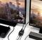A Ferris wheel and a city skyline are displayed on two monitors connected via an HDMI cable, with an adapter in between.