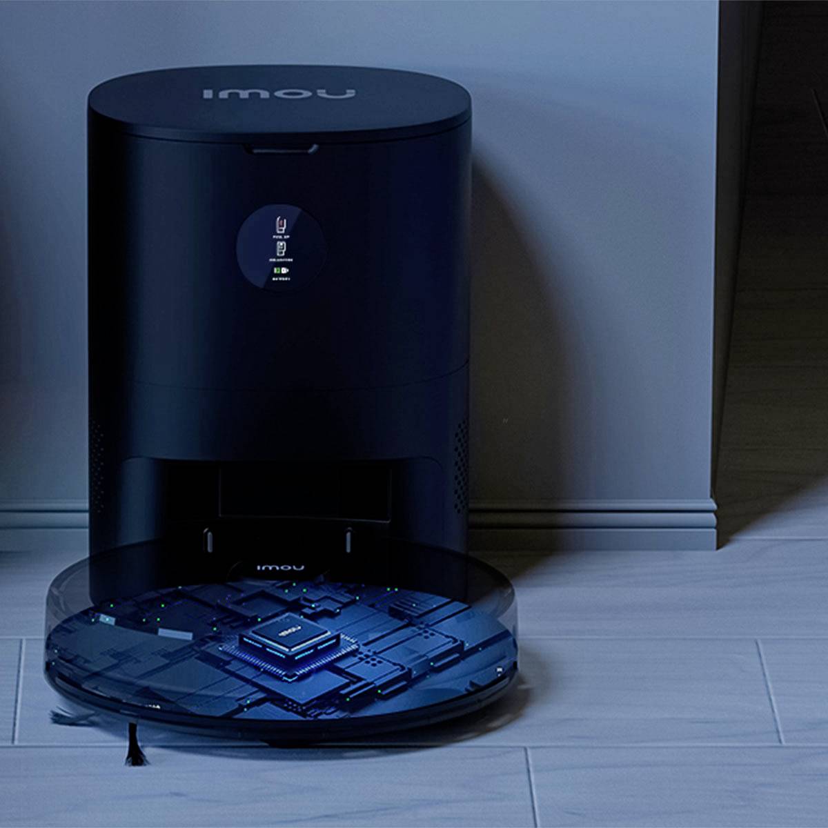 A round robotic vacuum docks at a charging station in a modern, illuminated room.