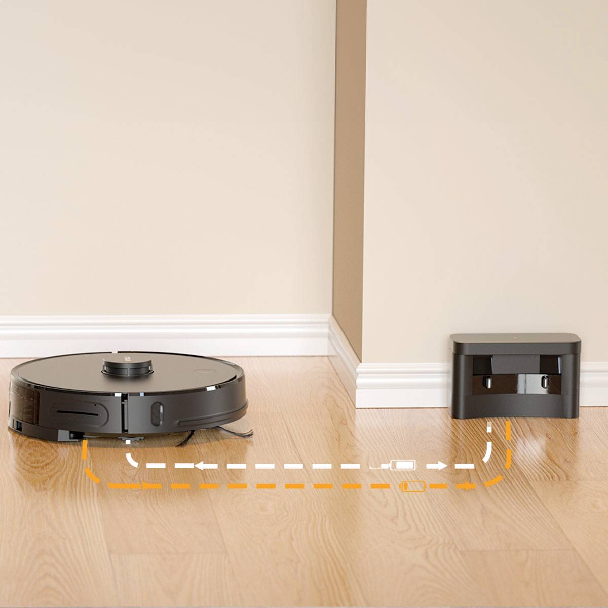 A round, black robotic vacuum cleaner moves across a wooden floor towards its charging station in the corner of the room.