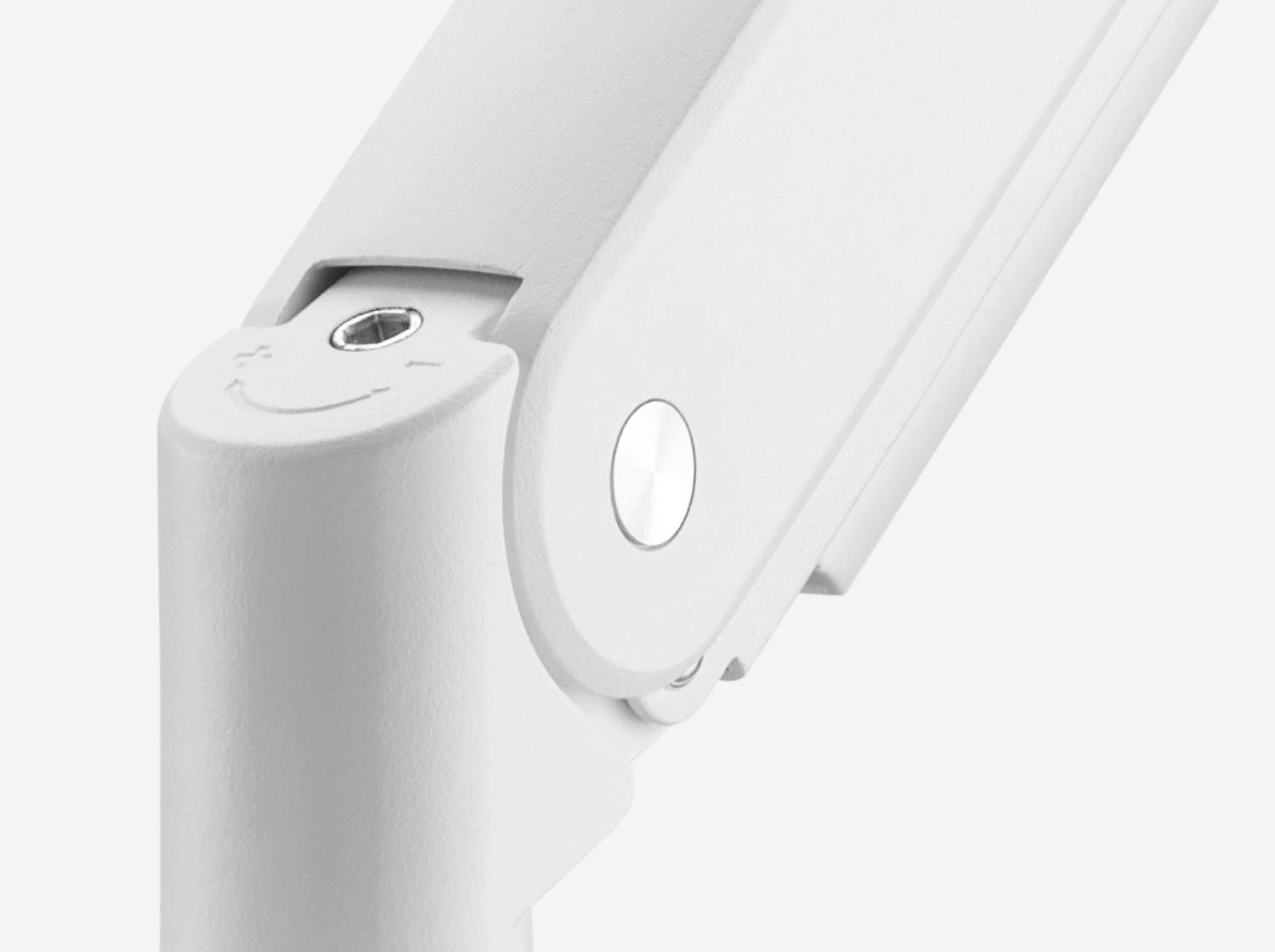 Close-up of a mechanical hinge with a screw, mounted on a light surface. It displays a simple, modern design.