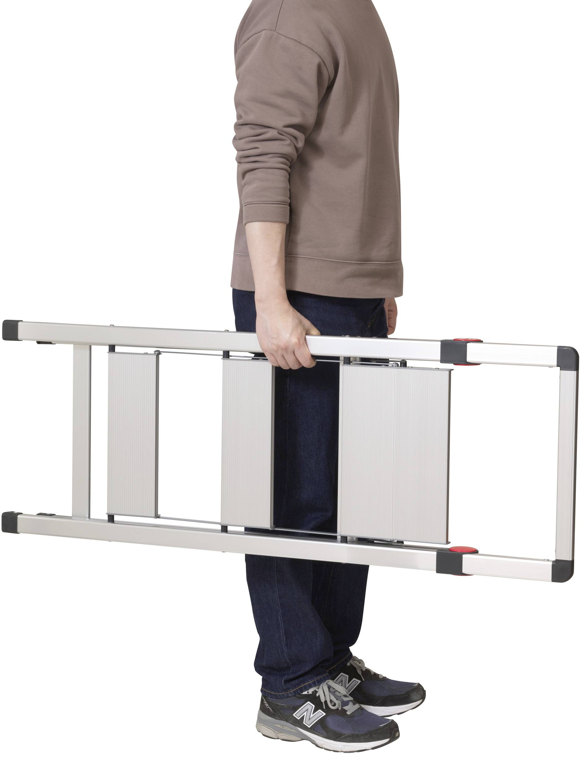 A person is holding a folded aluminium ladder horizontally.