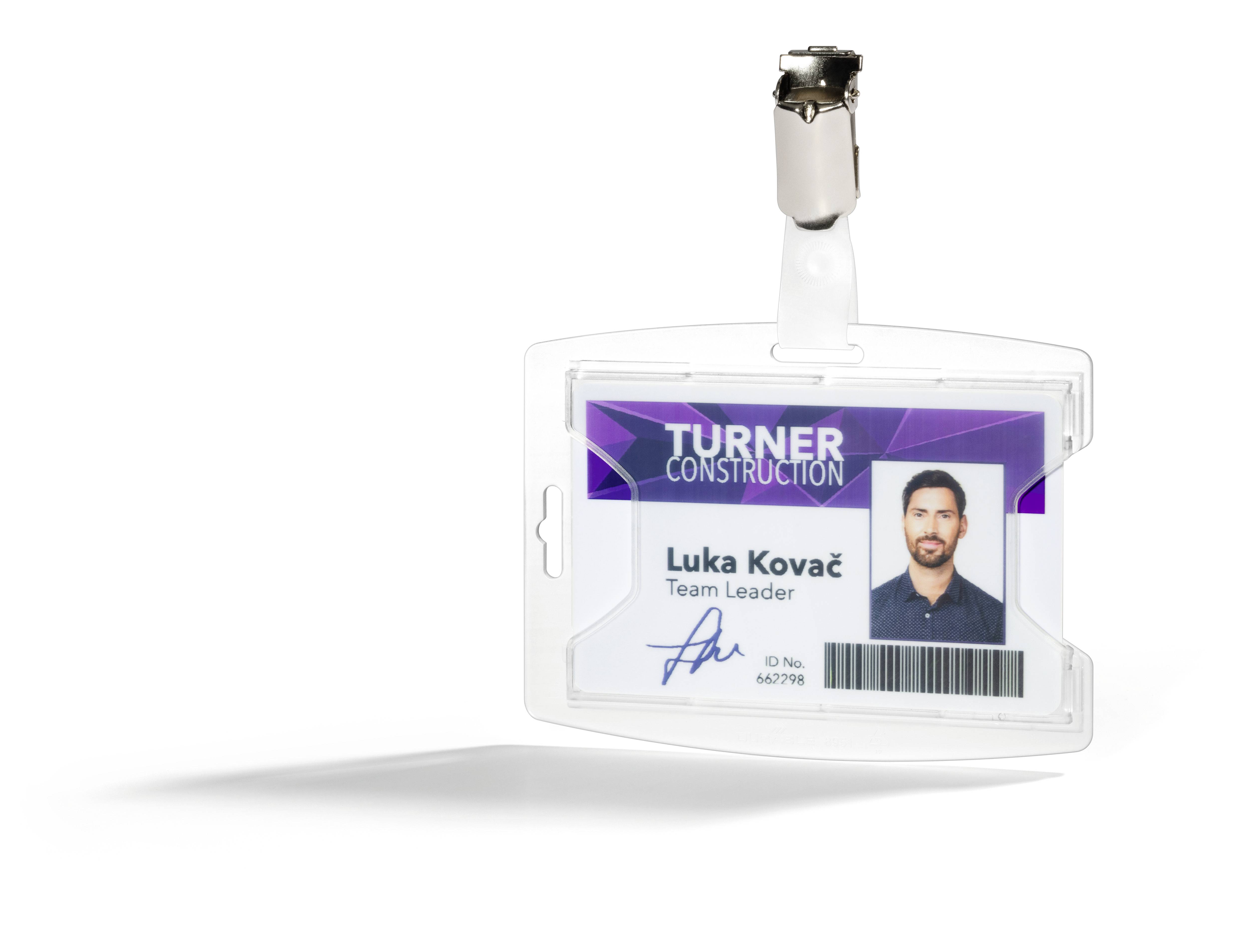 A plastic ID badge with a clip shows a photo. It reads 'Turner Construction' and underneath the name 'Luka Kovač, Team Leader'.