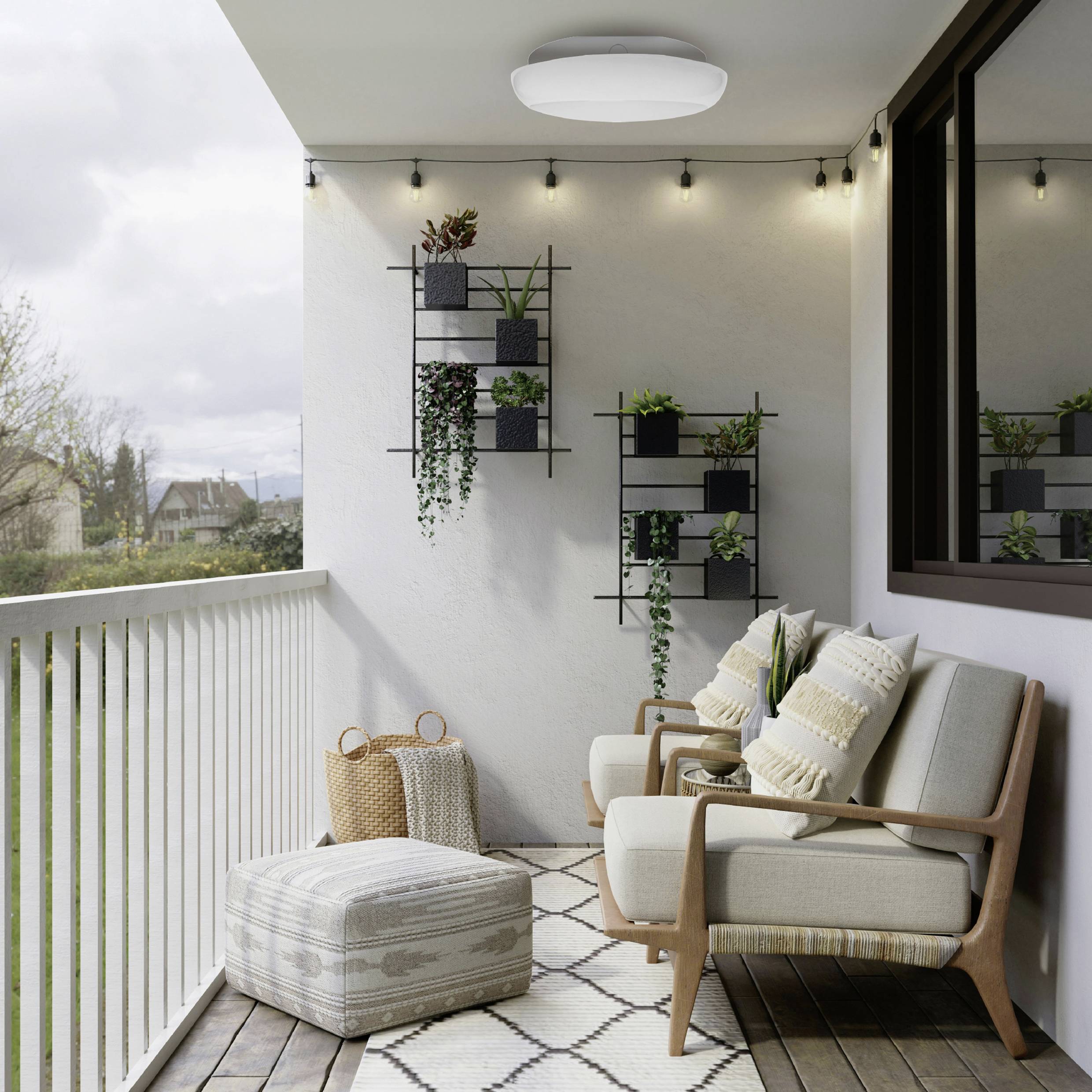 A cozy balcony with string lights, chairs, and a pouf; wall-mounted plants add greenery. A lush landscape is visible in the background.