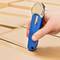 A hand is holding a blue box cutter over a cardboard box, ready to cut. The cardboard box is neatly folded and sealed.