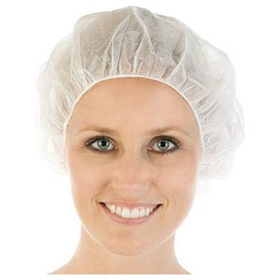 A person wearing a disposable hood smiles at the camera. They are wearing the hood as a hygiene or protective measure.