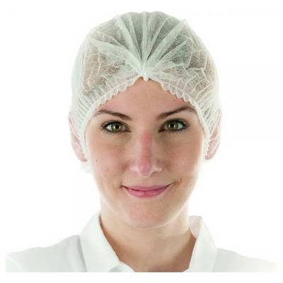 A person wearing a white disposable hair net is smiling, potentially working in a profession with hygiene regulations.