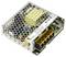 An open electronic power supply unit with a honeycomb cover, various components, and a yellow label displaying technical specifications.