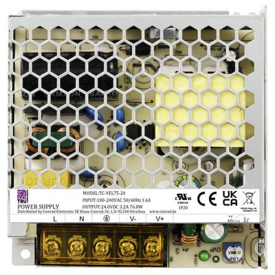 Power supply housing with mesh cover and electronic components inside; label with specifications and protection symbols visible.