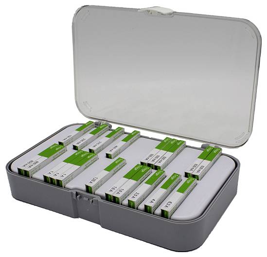 An open box containing various metal rulers in green boxes of different lengths, neatly arranged.