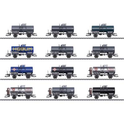 Twelve model railway tanker wagons in various colours and designs, arranged in four rows with three wagons per row.
