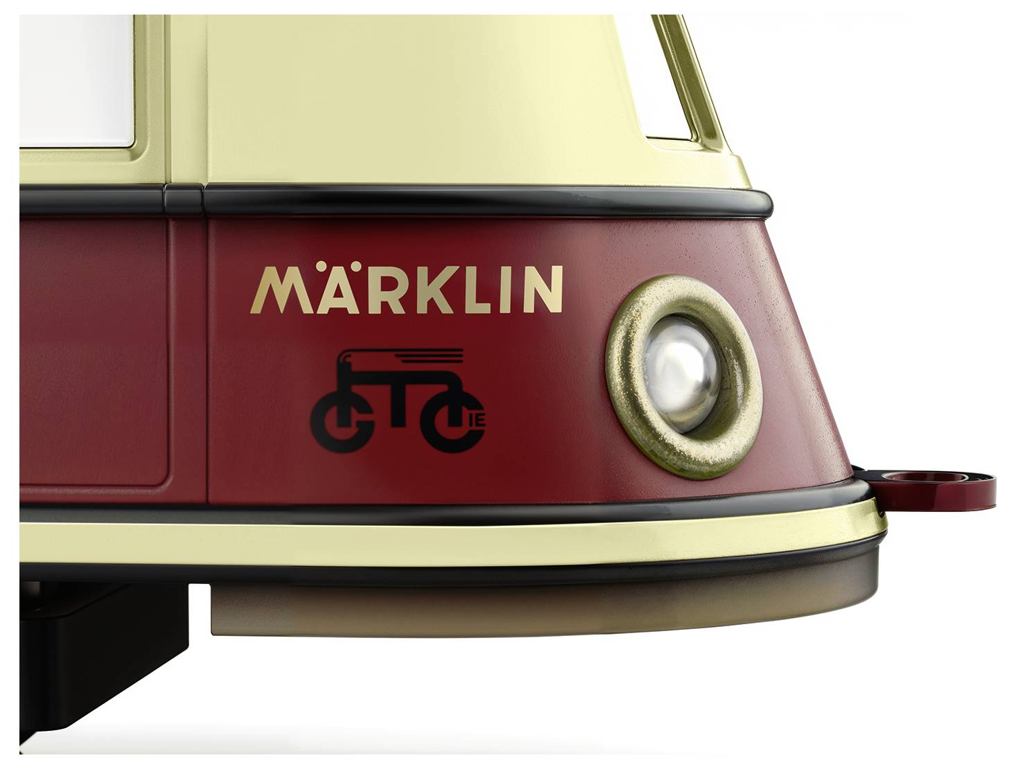 A partial section of a Märklin model train, painted beige and red, with a stylised bicycle symbol on the side.