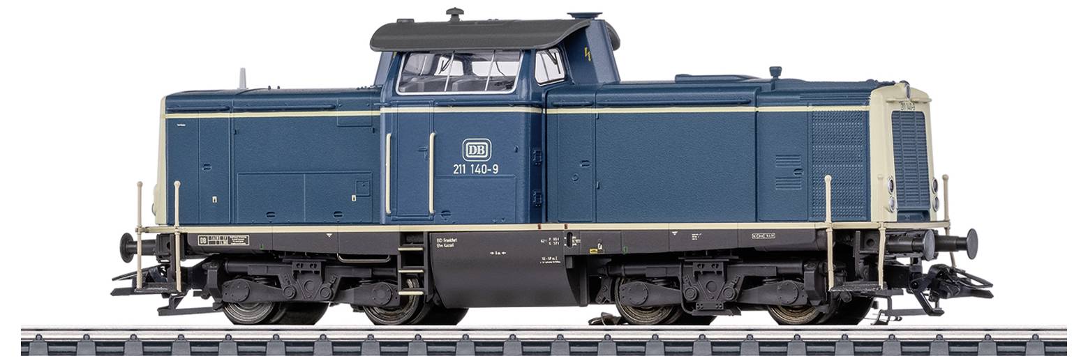 A blue and white painted train is standing on a section of railway track. The train has the number '211 149-3'.