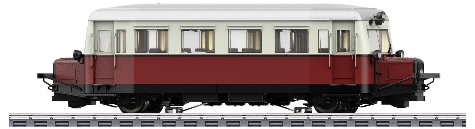 A red and white railcar stands on tracks. The railcar has multiple windows and a front headlight, ready for departure.
