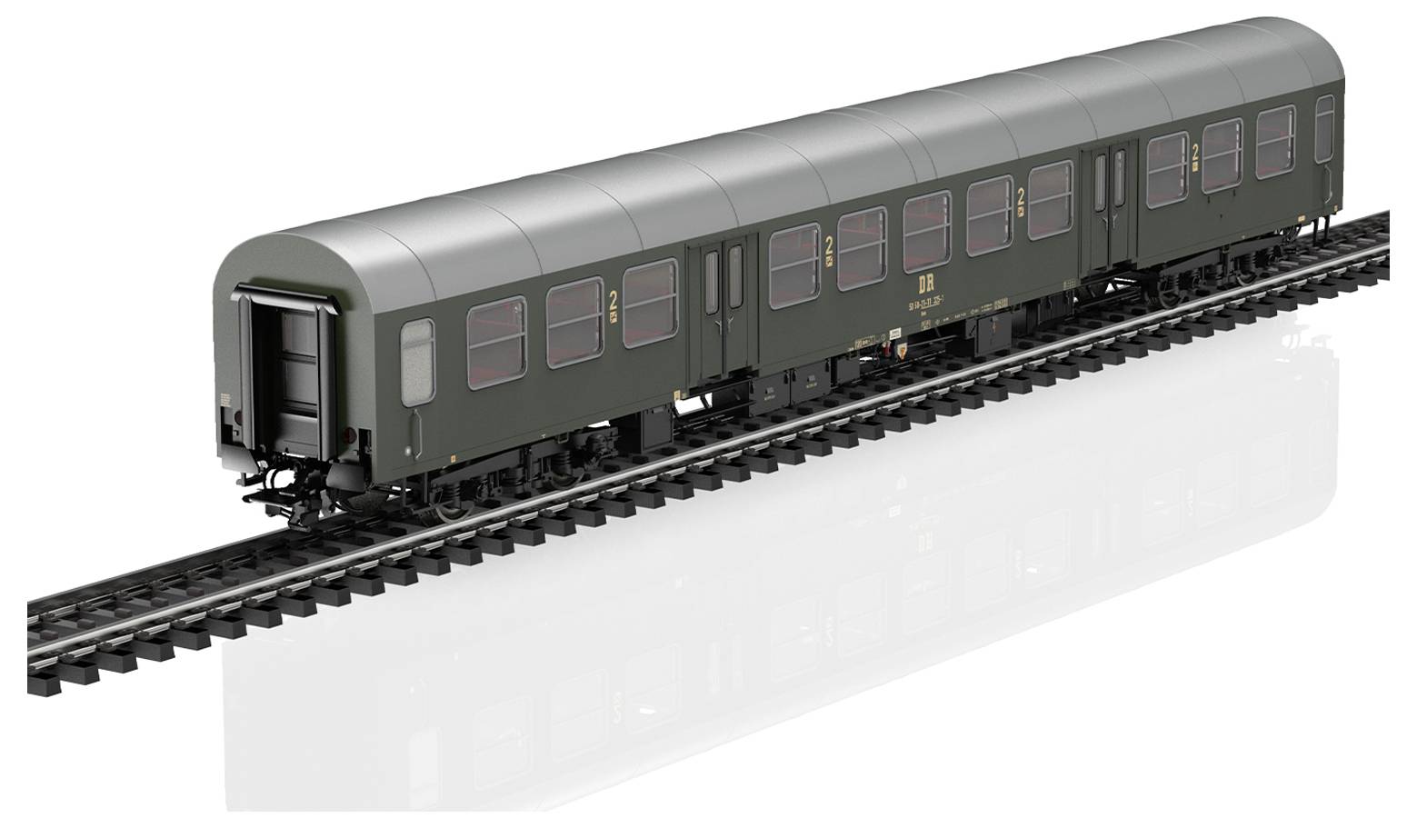 A model of a green railway carriage on tracks with multiple windows and doors, resembling a passenger train car.