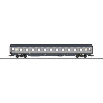 A grey passenger carriage on a railway track. The carriage has multiple windows and a yellow stripe along its side.