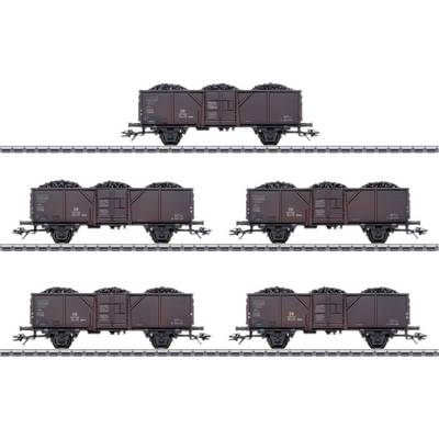 Six coal wagons on tracks, loaded with coal. The wagons are evenly distributed and arranged in two rows.