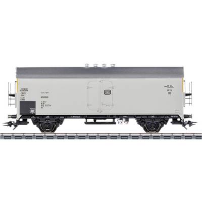 Grey model goods wagon on a track with detailed lettering and DB logo.