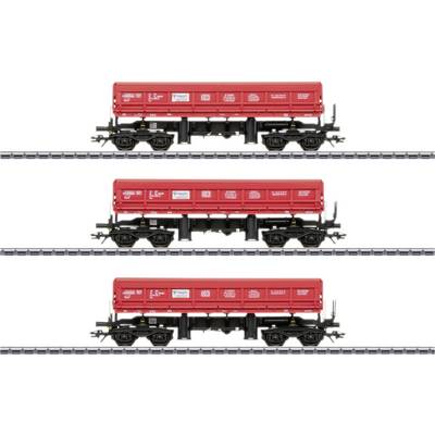 'Three red Deutsche Bahn freight wagons in a row on the tracks, pictured from the side, showing logos and technical details.'